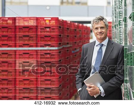 Portrait of confident supervisor with digital tablet in food processing plant View Large Photo Image Stock Image - Portrait of confident supervisor with digital tablet in food processing plant. Fotosearch