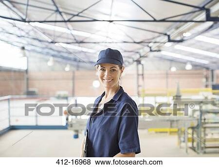 Portrait of confident worker in food processing plant View Large Photo Image Stock Photo - Portrait of confident worker in food processing plant. Fotosearch