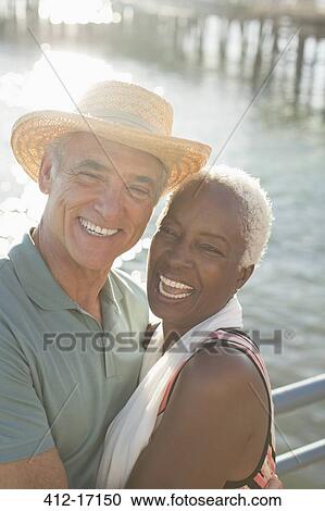 Portrait of enthusiastic couple hugging at oceanfront View Large Photo Image Stock Image - Portrait of enthusiastic couple hugging at oceanfront. Fotosearch