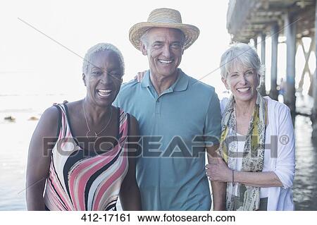 Portrait of happy senior friends at beach View Large Photo Image Stock Image - Portrait of happy senior friends at beach. Fotosearch