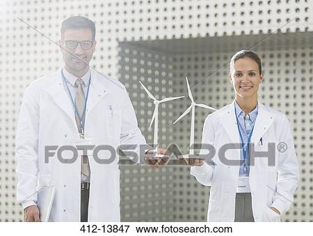 Portrait of scientists holding wind turbine models View Large Photo Image Stock Photo - Portrait of scientists holding wind turbine models. Fotosearch