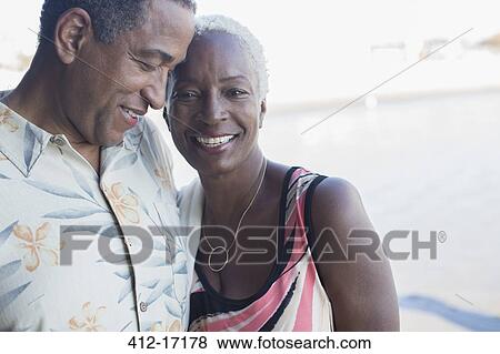 Stock Photo - Portrait of senior couple hugging. Fotosearch