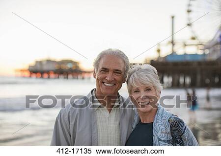 Portrait of smiling senior couple at beach View Large Photo Image Stock Photography - Portrait of smiling senior couple at beach. Fotosearch