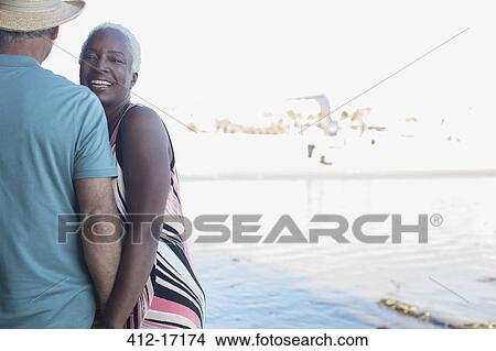 Portrait of smiling senior couple on beach View Large Photo Image Picture - Portrait of smiling senior couple on beach. Fotosearch