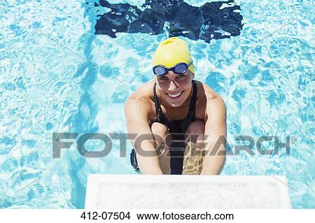 Portrait of smiling swimmer poised at starting block View Large Photo Image Picture - Portrait of smiling swimmer poised at starting block. Fotosearch