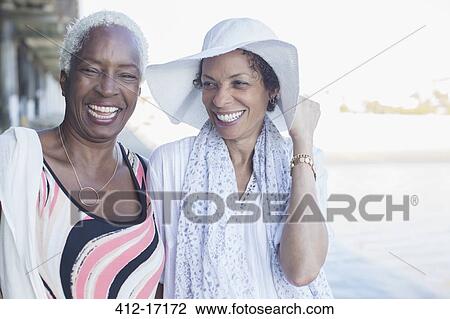 Portrait of smiling women at beach View Large Photo Image Stock Image - Portrait of smiling women at beach. Fotosearch