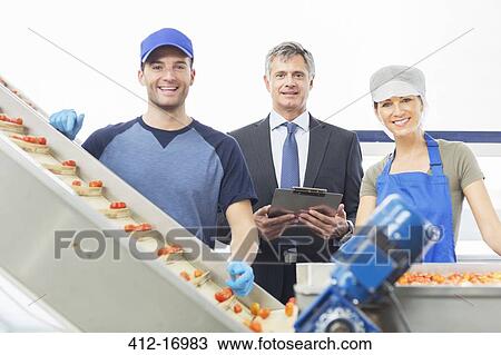 Portrait of supervisor and workers in food processing plant View Large Photo Image Stock Image - Portrait of supervisor and workers in food processing plant. Fotosearch