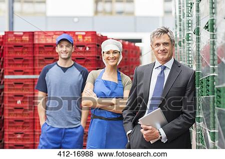 Stock Photo - Portrait of supervisor and workers in food processing plant. Fotosearch