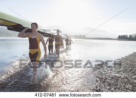 Rowing crew carrying scull out of lake View Large Photo Image Stock Image - Rowing crew carrying scull out of lake. Fotosearch