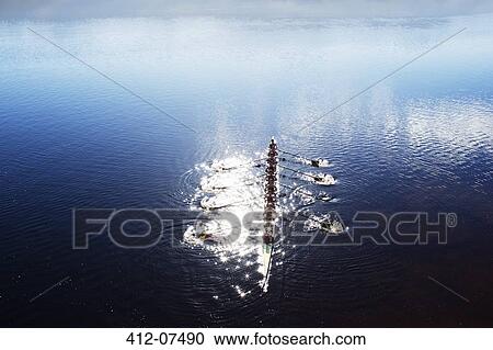 Rowing team rowing scull on lake View Large Photo Image Stock Image - Rowing team rowing scull on lake. Fotosearch