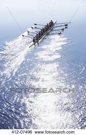 Rowing team rowing scull on sunny lake View Large Photo Image Stock Photograph - Rowing team rowing scull on sunny lake. Fotosearch