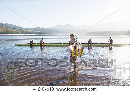 Rowing team with oars and scull on lake View Large Photo Image Stock Photo - Rowing team with oars and scull on lake. Fotosearch