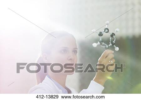 Scientist examining molecule model View Large Photo Image Stock Photo - Scientist examining molecule model. Fotosearch