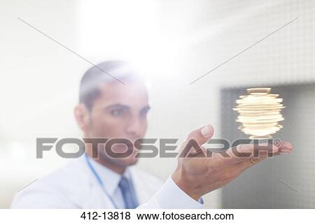 Scientist holding molecule model View Large Photo Image Stock Photo - Scientist holding molecule model. Fotosearch