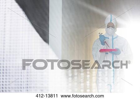 Scientist in clean suit with pipette and tray View Large Photo Image Stock Image - Scientist in clean suit with pipette and tray. Fotosearch