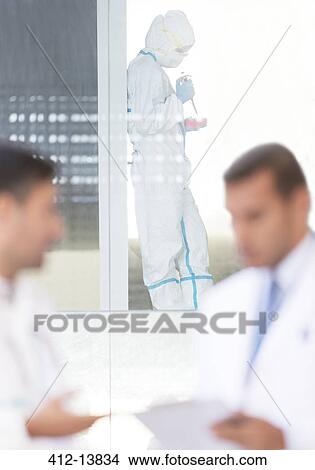 Picture - Scientist in clean suit working in laboratory. Fotosearch