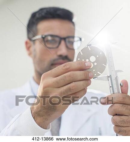 Scientist using caliper View Large Photo Image Stock Photograph - Scientist using caliper. Fotosearch