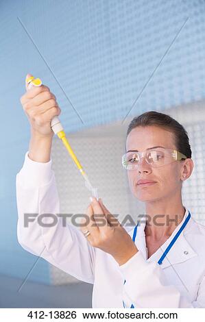 Scientist using pipette and test tube in laboratory View Large Photo Image Stock Photograph - Scientist using pipette and test tube in laboratory. Fotosearch
