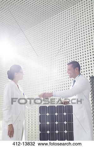 Scientists handshaking at solar panel in laboratory View Large Photo Image Stock Image - Scientists handshaking at solar panel in laboratory. Fotosearch