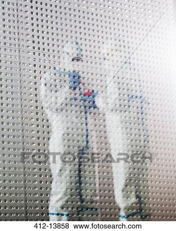 Stock Photo - Scientists in clean suits working in laboratory. Fotosearch