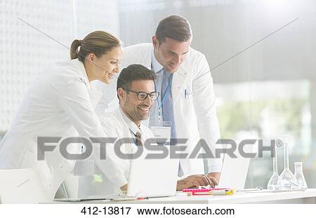 Scientists working in laboratory View Large Photo Image Stock Photo - Scientists working in laboratory. Fotosearch