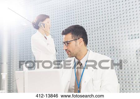 Scientists working in laboratory View Large Photo Image Stock Photograph - Scientists working in laboratory. Fotosearch