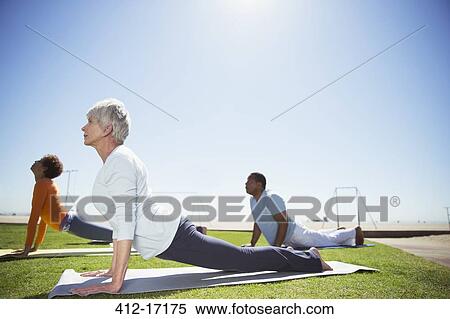 Seniors practicing yoga in sunny beach park View Large Photo Image Stock Photography - Seniors practicing yoga in sunny beach park. Fotosearch