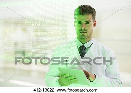 Serious doctor using digital tablet in hospital View Large Photo Image Stock Image - Serious doctor using digital tablet in hospital. Fotosearch