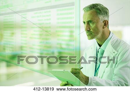 Serious doctor with clipboard View Large Photo Image Stock Photo - Serious doctor with clipboard. Fotosearch