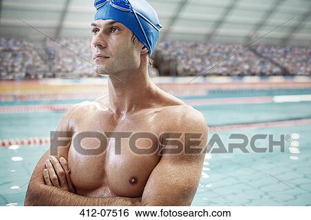 Serious swimmer standing poolside View Large Photo Image Stock Photograph - Serious swimmer standing poolside. Fotosearch
