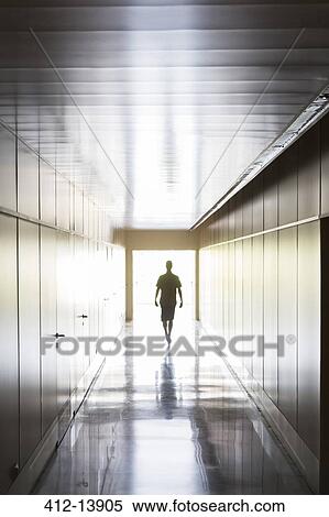 Silhouette of person walking in corridor View Large Photo Image Stock Photography - Silhouette of person walking in corridor. Fotosearch