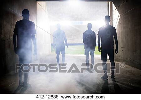 Stock Photo - Silhouette of soccer teams facing field. Fotosearch
