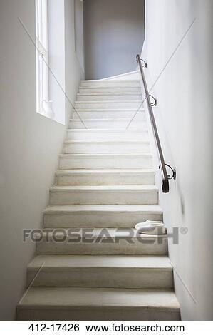 Stock Photograph - Slippers on whitewashed staircase. Fotosearch