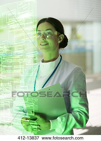 Smiling doctor with clipboard in hospital View Large Photo Image Stock Photo - Smiling doctor with clipboard in hospital. Fotosearch