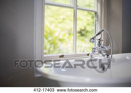 Stock Image - Soaking tub at window in bathroom. Fotosearch
