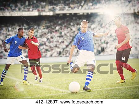Soccer player kicking ball on field View Large Photo Image Stock Photo - Soccer player kicking ball on field. Fotosearch