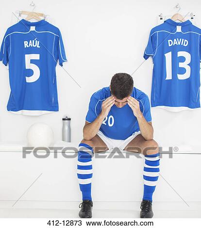 Soccer player with head in hands in locker room View Large Photo Image Stock Image - Soccer player with head in hands in locker room. Fotosearch