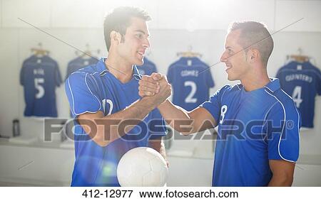 Soccer players shaking hands in locker room View Large Photo Image Stock Photo - Soccer players shaking hands in locker room. Fotosearch
