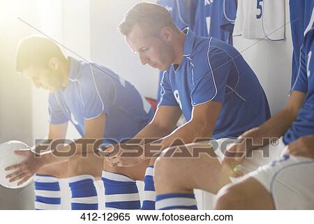 Soccer players sitting in locker room View Large Photo Image Stock Photography - Soccer players sitting in locker room. Fotosearch