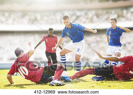 Stock Photo - Soccer players sliding on field. Fotosearch