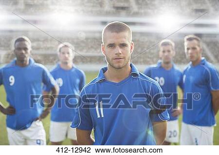 Soccer players standing on field View Large Photo Image Stock Image - Soccer players standing on field. Fotosearch