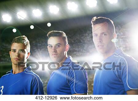 Stock Photograph - Soccer players standing on field. Fotosearch