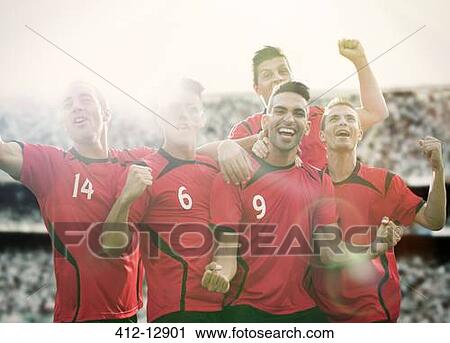 Stock Image - Soccer team celebrating on field. Fotosearch