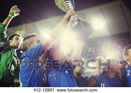 Soccer team celebrating with trophy on field View Large Photo Image Stock Image - Soccer team celebrating with trophy on field. Fotosearch