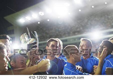 Soccer team celebrating with trophy on field View Large Photo Image Stock Image - Soccer team celebrating with trophy on field. Fotosearch