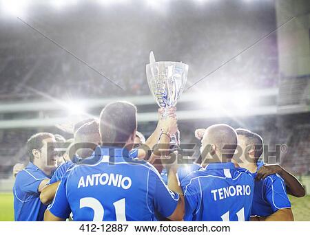 Soccer team celebrating with trophy on field View Large Photo Image Stock Photo - Soccer team celebrating with trophy on field. Fotosearch