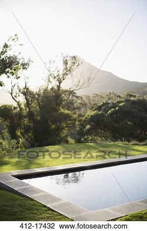 Sun shining over mountain and luxury lap pool View Large Photo Image Stock Image - Sun shining over mountain and luxury lap pool. Fotosearch