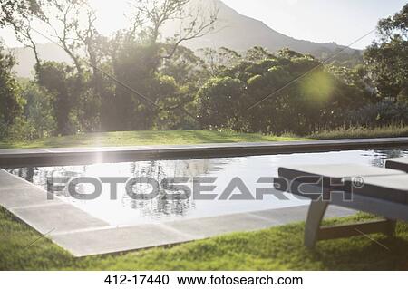 Sunny backyard with lap pool View Large Photo Image Stock Image - Sunny backyard with lap pool. Fotosearch