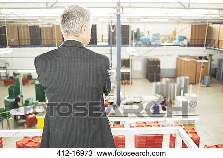 Supervisor watching workers in food processing plant View Large Photo Image Stock Image - Supervisor watching workers in food processing plant. Fotosearch