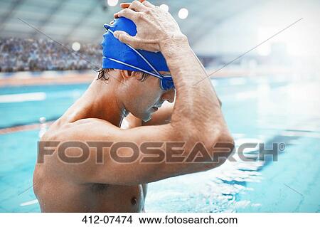 Swimmer adjusting cap at poolside View Large Photo Image Picture - Swimmer adjusting cap at poolside. Fotosearch